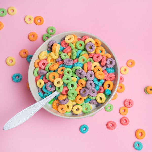 Bowl of colorful cereal with spoon.